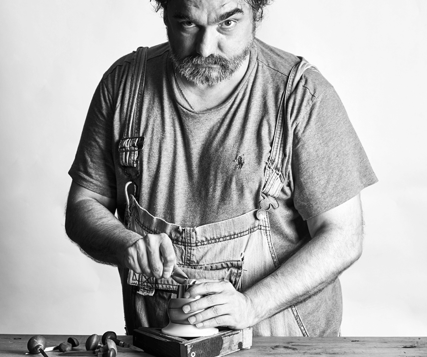 Black and white photograph of a specialist Rebus signet ring engraver in the workshop